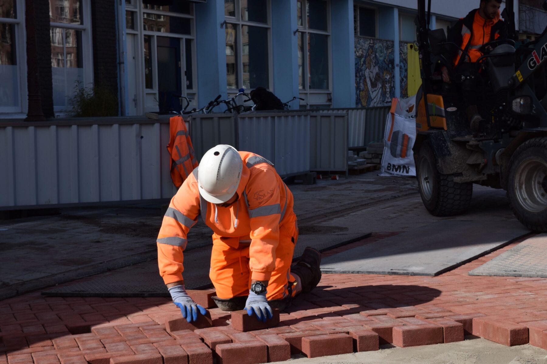 Stratenmaker legt een steen in de straat
