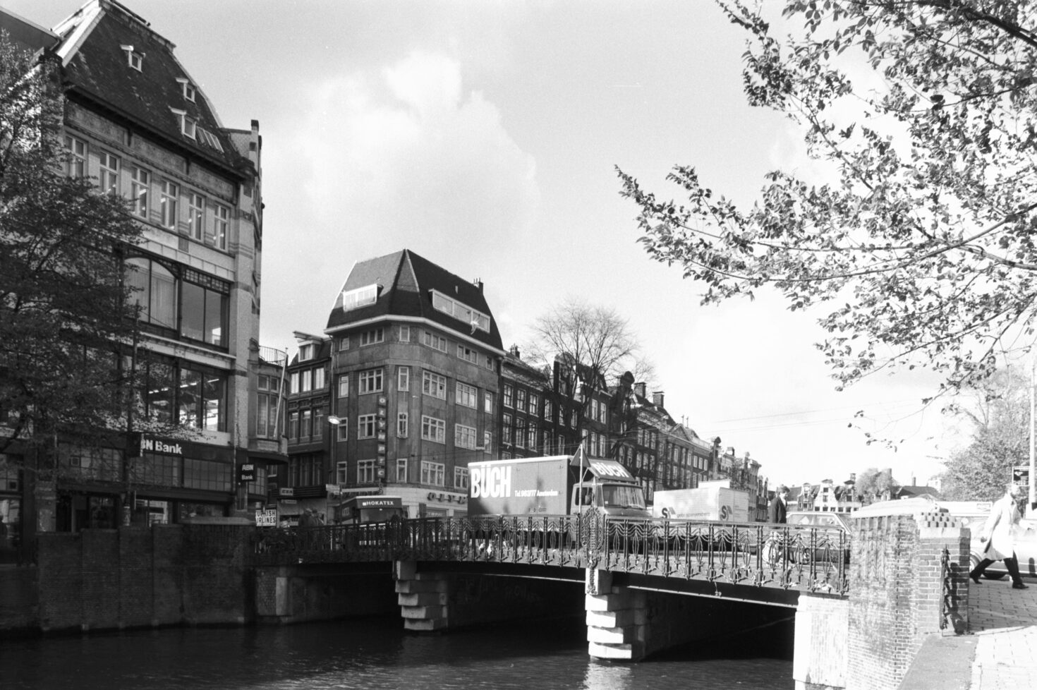 Druk verkeer op de brug van de Koningssluis. Gezien vanaf de Herengracht kant Koningsplein richting Leidsestraat